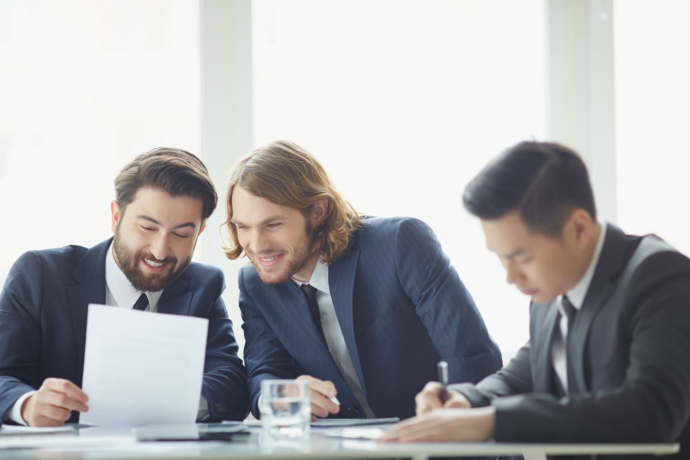 co-workers-reading-document-together